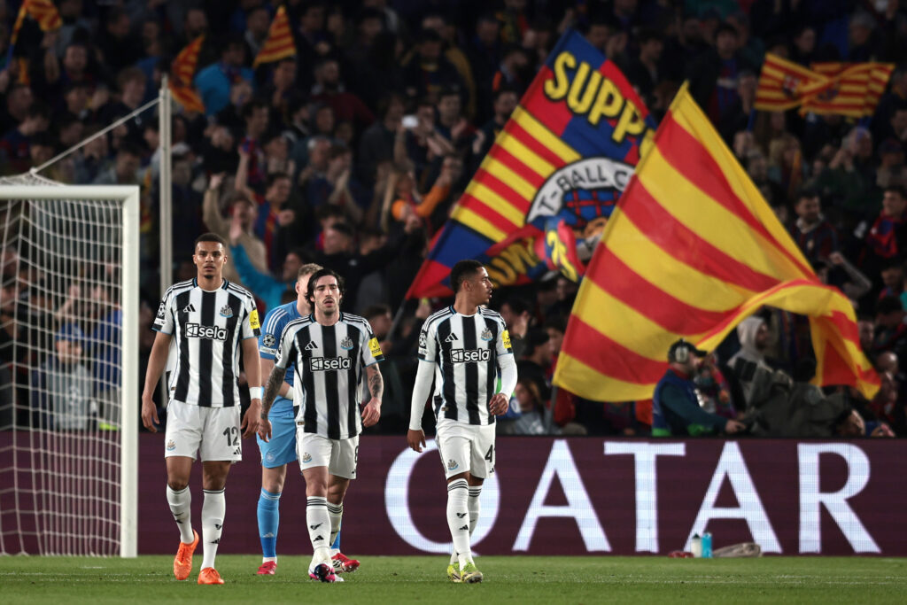 Newcastle United players look dejected after conceding against FC Barcelona in the Champions League.