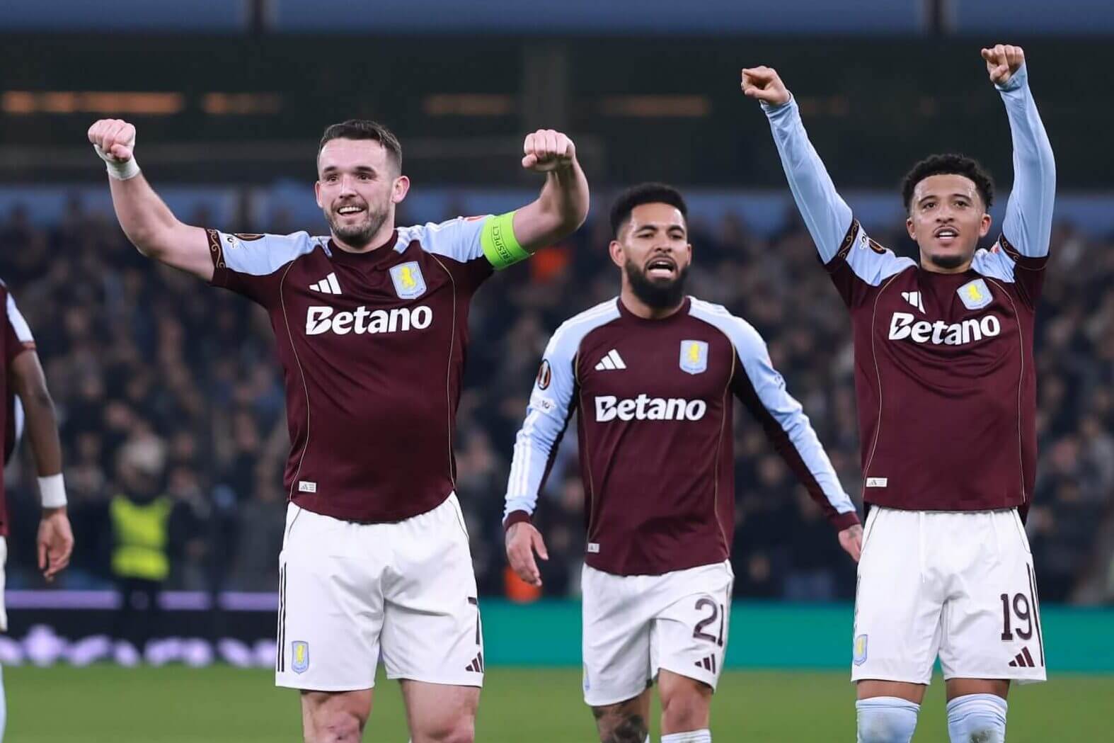 John McGinn, Douglas Luiz and Jadon Sancho celebrate Aston Villa's opening goal against Lille
