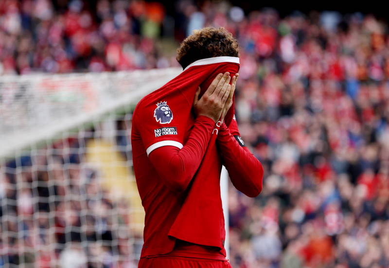 Curtis Jones pulls his Liverpool shirt up to cover his face after missing a chance