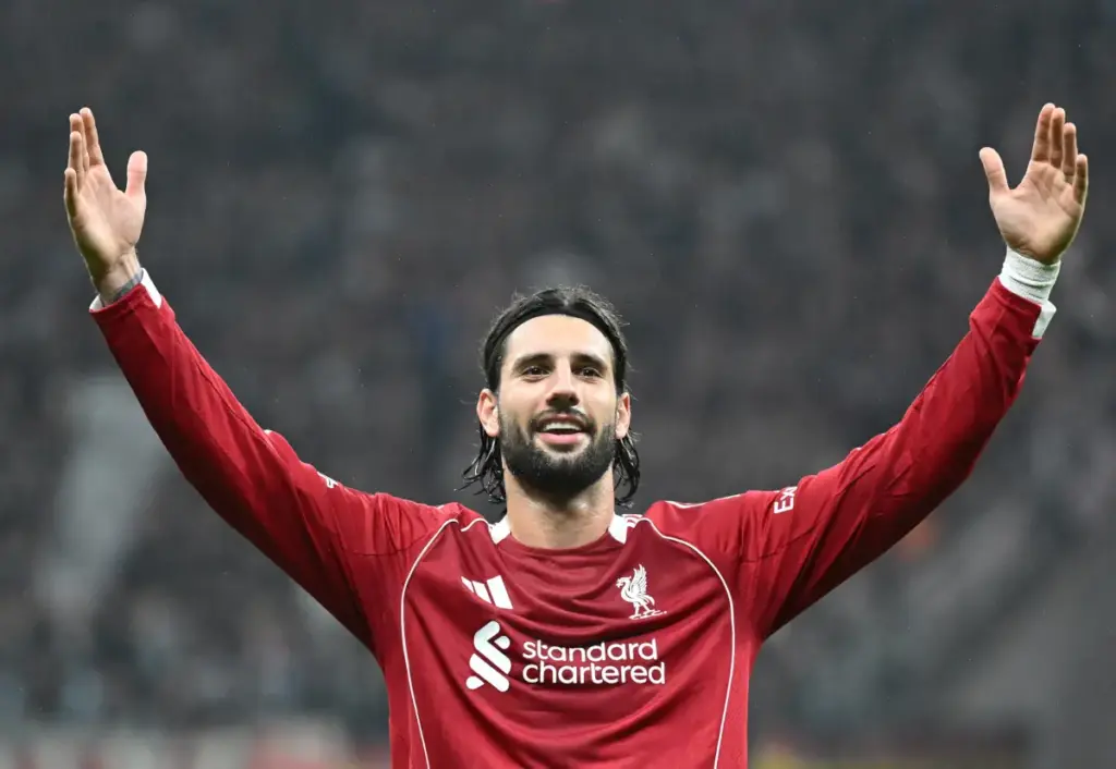 Analyst Says What Liverpool’s Szoboszlai Missing To Become Best Dominik Szoboszlai stands with arms outstretched after scoring for Liverpool