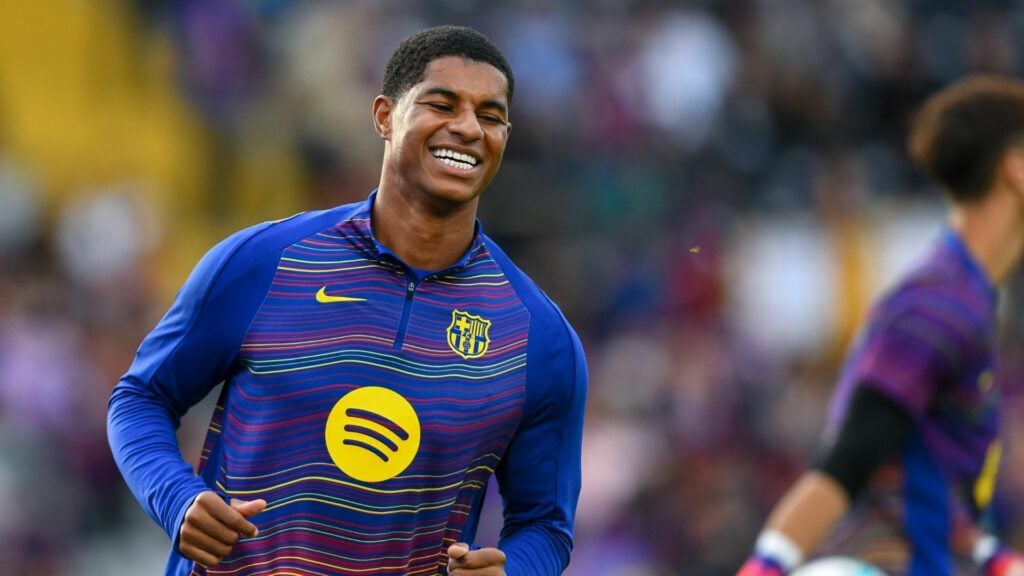 Ex-Aston Villa loanee Marcus Rashford smiles while warming up for Barcelona.