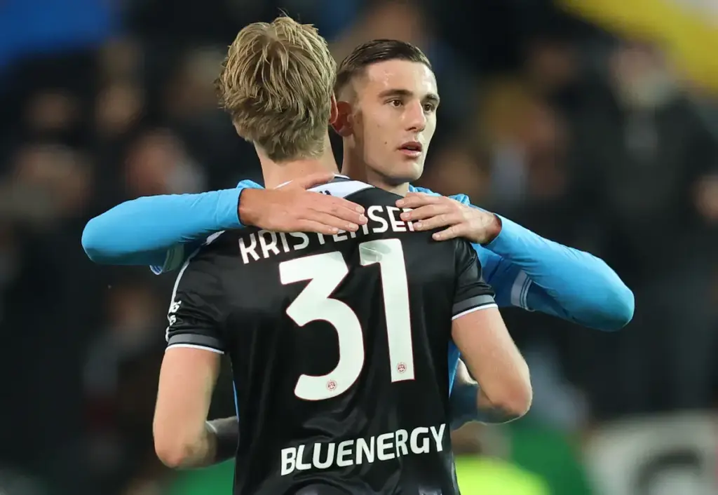 Napoli striker Lorenzo Lucca hugs Udinese star Thomas Kristensen at the end of a game