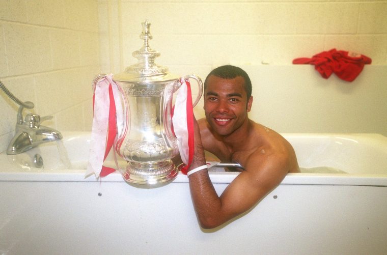 CARDIFF, WALES - MAY 21: Ashley Cole of Arsenal with the FA Cup Trophy in the bath after the FA Cup Final match between Arsenal and Manchester United on May 21, 2005 in Cardiff, Wales. (Photo by Stuart MacFarlane/Arsenal FC via Getty Images)