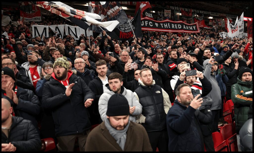 MANCHESTER, ENGLAND - NOVEMBER 24: Fans of Manchester United show their support prior to the Premier League match between Manchester United and Everton at Old Trafford on November 24, 2025 in Manchester, England.