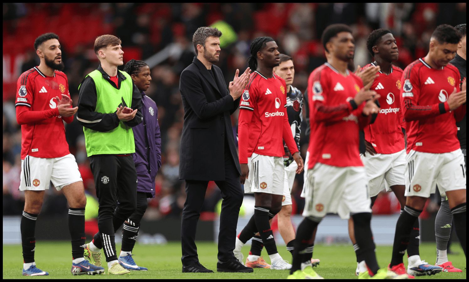 MANCHESTER, ENGLAND - MARCH 01: Michael Carrick, Manager of Manchester United, applauds the fans after the team's victory in the Premier League match between Manchester United and Crystal Palace at Old Trafford on March 01, 2026 in Manchester, England.