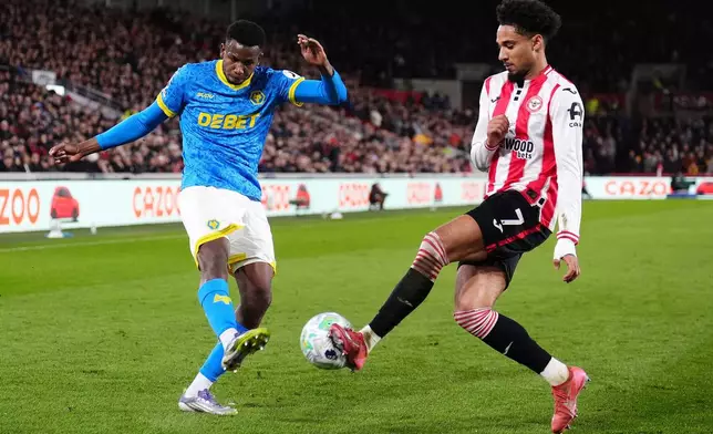 Wolverhampton Wanderers' Yerson Mosquera, left, and Brentford's Kevin Schade in action during the English Premier League soccer match between Brentford and Wolverhampton Wanderers in London, Monday March 16, 2026. (John Walton/PA via AP)