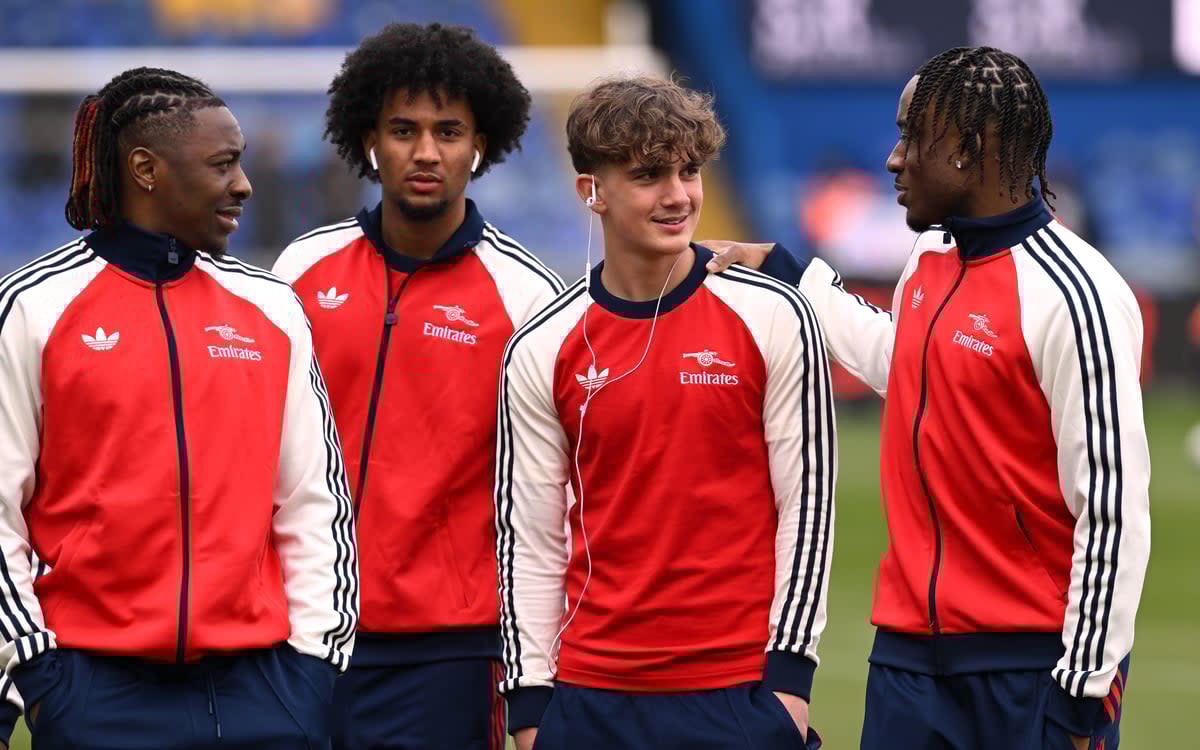 At home: Dowman inspects the pitch alongside his Arsenal team-mates (Arsenal FC via Getty Images)