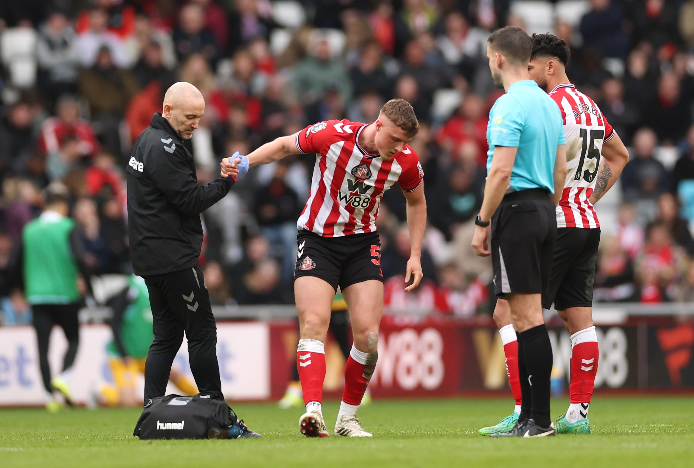 SUNDERLAND, ENGLAND - MARCH 14: Daniel Ballard of Sunderland leaves the field with an injury during the Premier League match between Sunderland and Brighton & Hove Albion at Stadium of Light on March 14, 2026 in Sunderland, England. (Photo by Stu Forster/Getty Images)