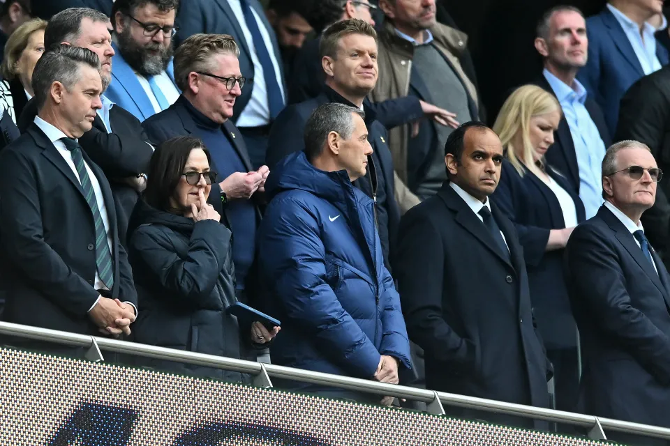Tottenham board standing in stadium at a match
