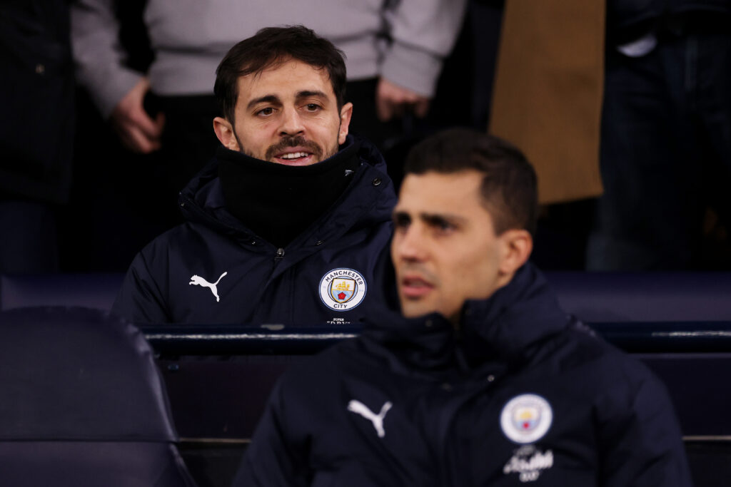 MANCHESTER, ENGLAND - FEBRUARY 04: Bernardo Silva of Manchester City looks on in the stands prior to the Carabao Cup Semi Final Second Leg match between Manchester City and Newcastle United at Etihad Stadium on February 04, 2026 in Manchester, England. (Photo by Kate McShane/Getty Images)