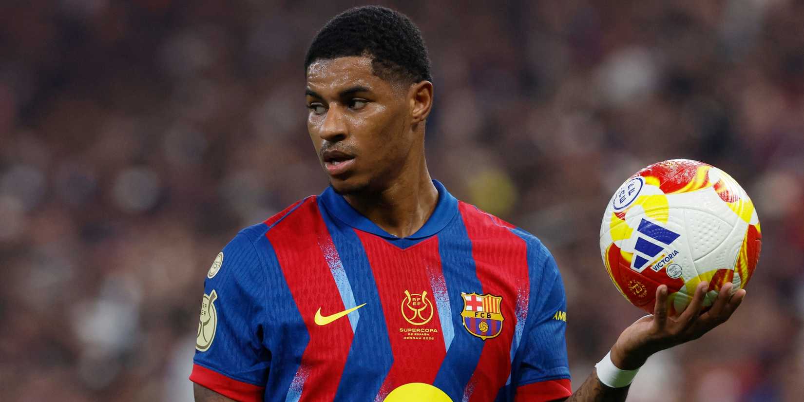 FC Barcelona's Marcus Rashford holds a football