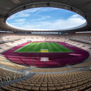Before and after of Sevilla's football stadium with olympic running track removed.