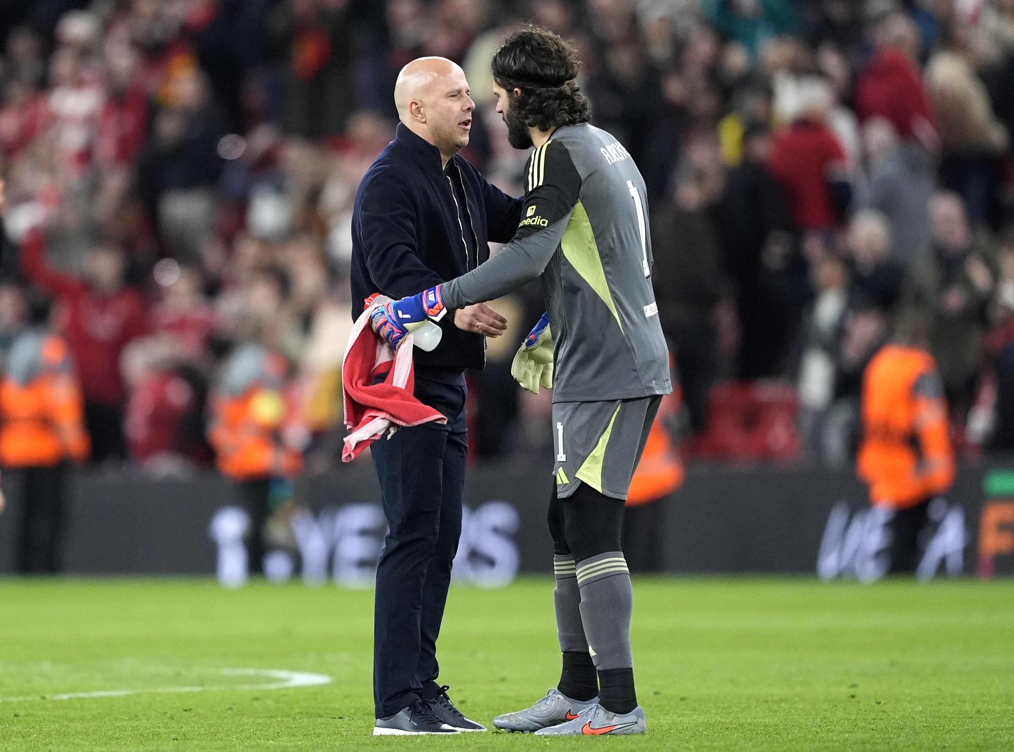 Arne Slot (left) would not commit either way over the future of his goalkeeper