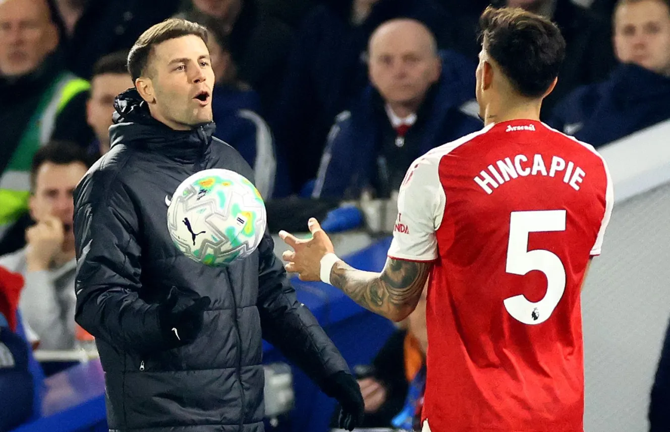 Brighton and Hove Albion Manager Fabian Hurzeler and Arsenal player Piero Hincapie speak during a match.