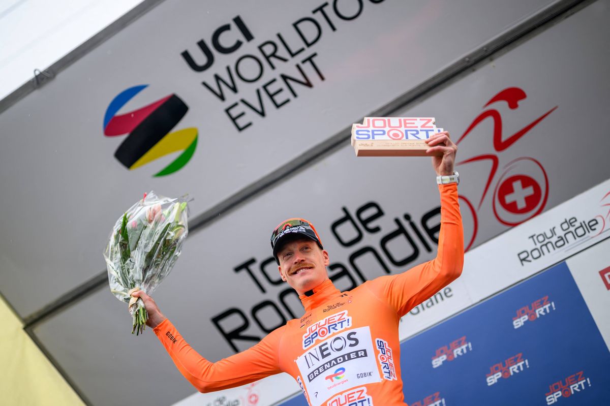 INEOS Grenadiers' French rider Dorian Godon celebrates on the podium after winning the prologue of the Tour of Romandie UCI cycling World tour, a 3.2 km time trial from Villars-sur-Glane to Villars-sur-Glane