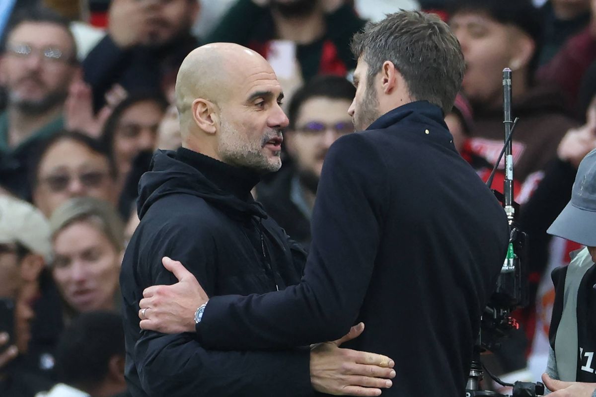 Manchester City's Spanish manager Pep Guardiola (L) speaks with Manchester United's English Interim head coach Michael Carrick (R) after the English Premier League football match between Manchester United and Manchester City at Old Trafford in Manchester, north west England,