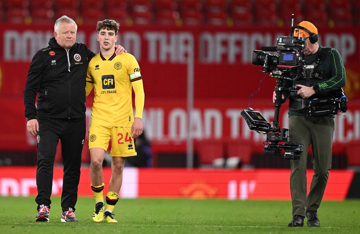 Sheffield United's English manager Chris Wilder (L) consoles Sheffield United's English midfielder #24 Oliver Arblaster after the English Premier League football match between Manchester United and Sheffield United at Old Trafford in Manchester, north west England, on April 24, 2024. (Photo by Oli SCARFF / AFP) / RESTRICTED TO EDITORIAL USE. No use with unauthorized audio, video, data, fixture lists, club/league logos or 'live' services. Online in-match use limited to 120 images. An additional 40 images may be used in extra time. No video emulation. Social media in-match use limited to 120 images. An additional 40 images may be used in extra time. No use in betting publications, games or single club/league/player publications. /  (Photo by OLI SCARFF/AFP via Getty Images)