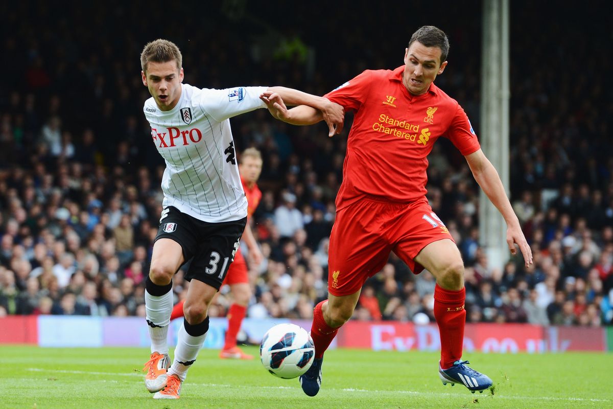 Alex Kacaniklic of Fulham battles with Stewart Downing of Liverpool