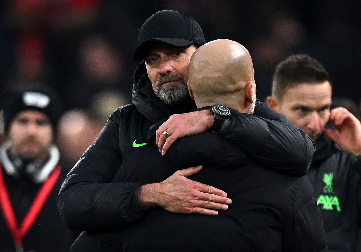 Liverpool's German manager Jurgen Klopp embraces Manchester City's Spanish manager Pep Guardiola at the end of the English Premier League football match between Liverpool and Manchester City at Anfield in Liverpool, north west England on March 10, 2024. The Match ended in a draw at 1-1. (Photo by Paul ELLIS / AFP) / RESTRICTED TO EDITORIAL USE. No use with unauthorized audio, video, data, fixture lists, club/league logos or 'live' services. Online in-match use limited to 120 images. An additional 40 images may be used in extra time. No video emulation. Social media in-match use limited to 120 images. An additional 40 images may be used in extra time. No use in betting publications, games or single club/league/player publications. /  (Photo by PAUL ELLIS/AFP via Getty Images)
