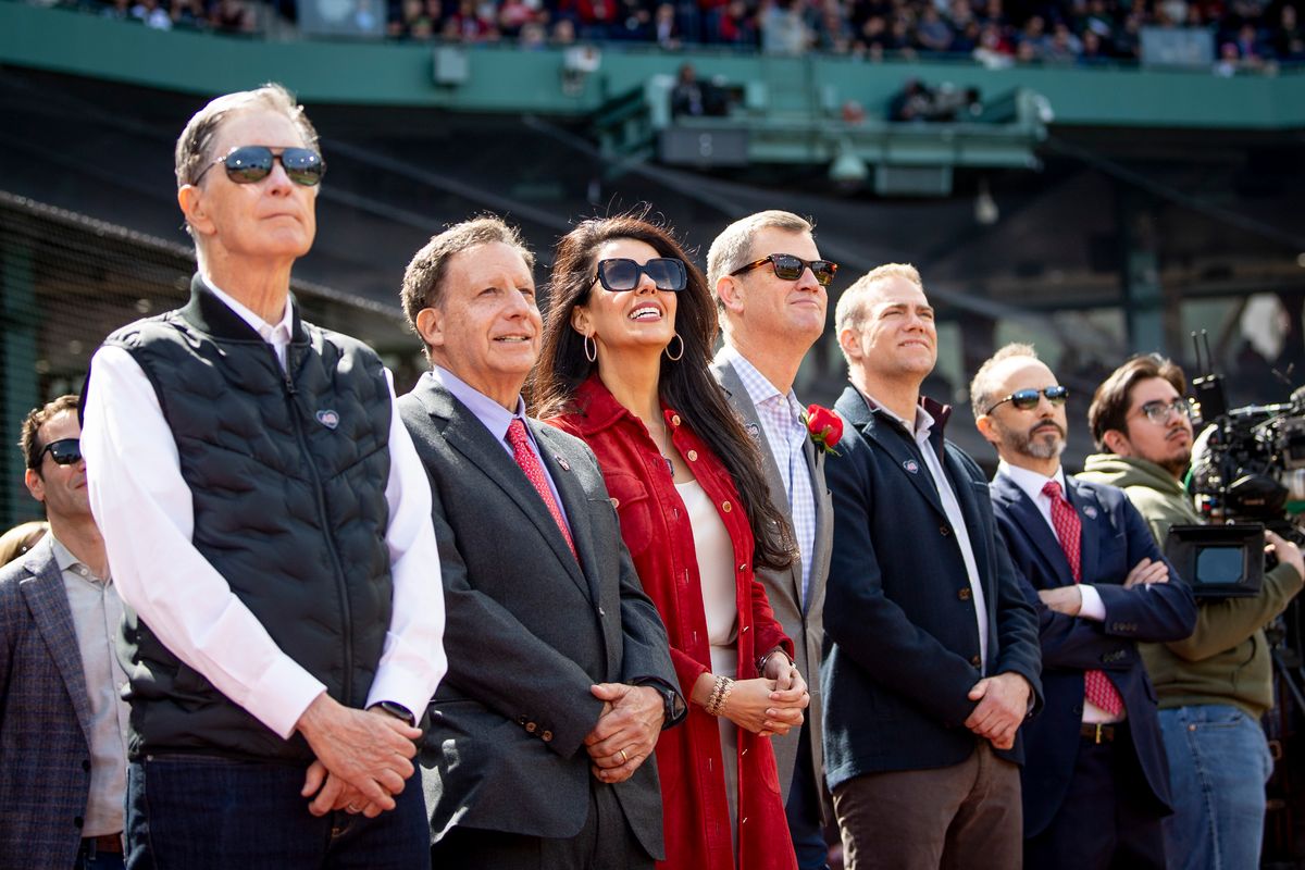 Boston Red Sox Principal Owner John Henry, Boston Red Sox chairman Tom Werner, Fenway Sports Group partner Linda Pizzuti Henry, Boston Red Sox President and CEO Sam Kennedy, Senior Adviser and part-owner of Fenway Sports Group Theo Epstein, and President of Fenway Sports Group Mike Gordon look on during pre-game ceremonies before the 2024 Opening Day game against the Baltimore Orioles