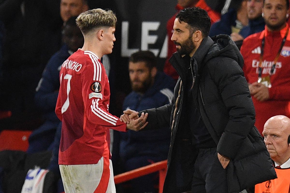 Manchester United's Portuguese head coach Ruben Amorim (R) shakes hands with Manchester United's Argentinian midfielder #17 Alejandro Garnacho (L) as he leaves the game, substituted during the UEFA Europa league quarter-final final, second leg football match between Manchester United and Lyon at Old Trafford stadium in Manchester, north west England, on April 17, 2025.