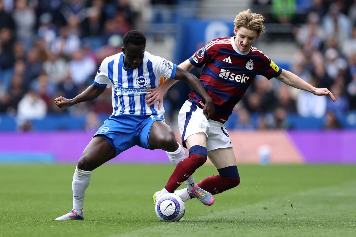 Yankuba Minteh of Brighton & Hove Albion battles for possession with Anthony Gordon of Newcastle United (Photo by Charlie Crowhurst/Getty Images)