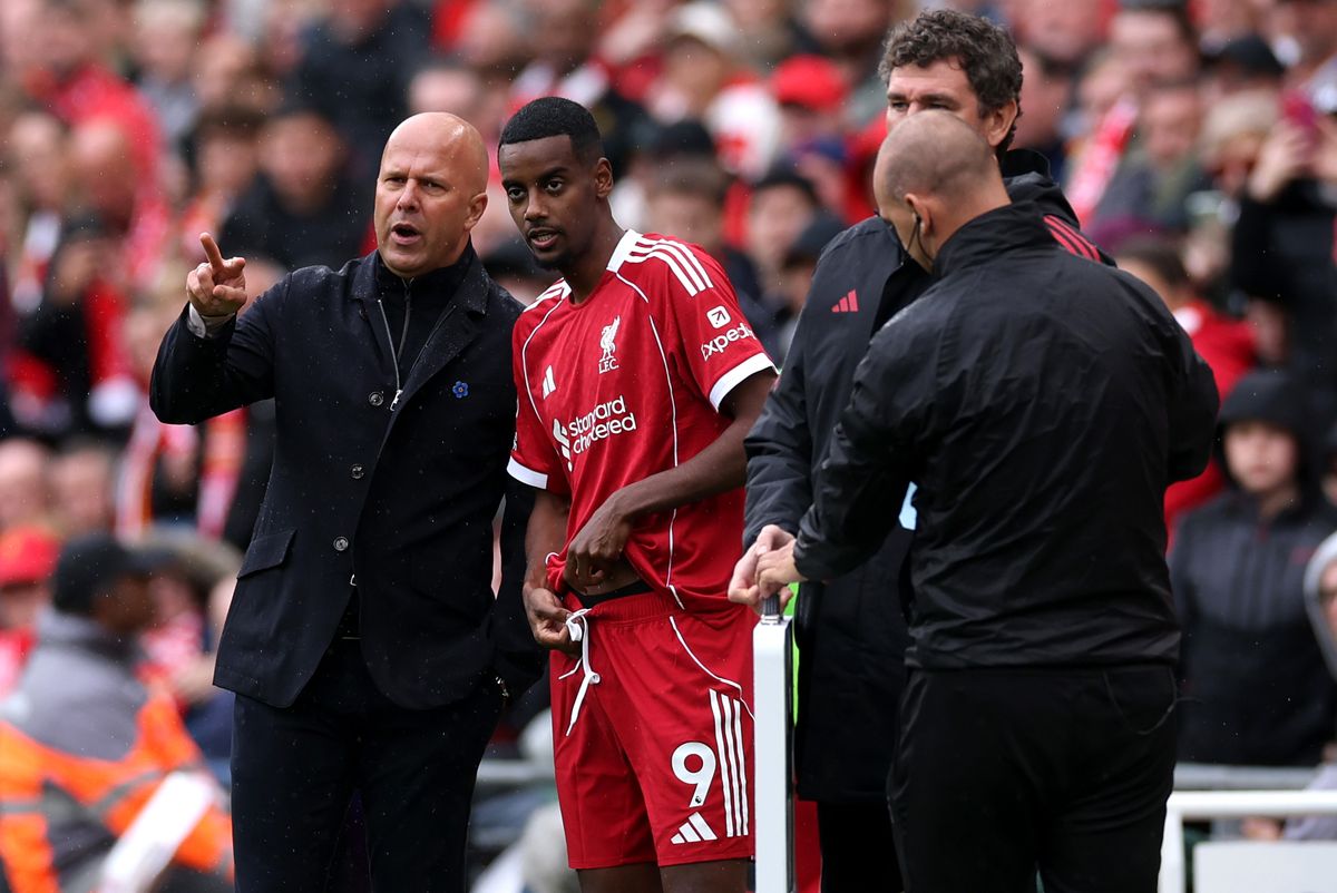LIVERPOOL, ENGLAND - SEPTEMBER 20: Alexander Isak of Liverpool receives instructions from Arne Slot, Manager of Liverpool, before coming on as a substitute during the Premier League match between Liverpool and Everton at Anfield on September 20, 2025 in Liverpool, England. (Photo by Stu Forster/Getty Images)