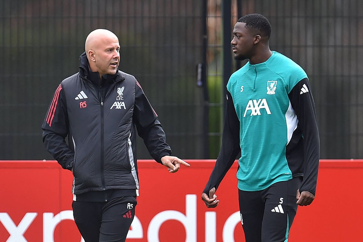 Liverpool's Dutch manager Arne Slot (L) speaks with Liverpool's French defender #05 Ibrahima Konate (R) during a training session at the team's training ground in Kirkby, north of Liverpool in north-west England, on November 3, 2025, on the eve of their UEFA Champions League league phase football match against Real Madrid.  (Photo by PETER POWELL / AFP) (Photo by PETER POWELL/AFP via Getty Images)          