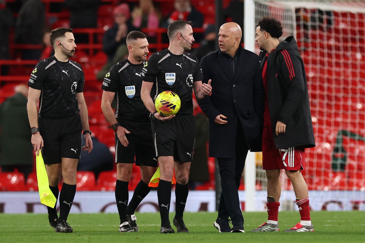 Arne Slot, Manager of Liverpool, and Curtis Jones of Liverpool speak to Referee Chris Kavanagh following the Premier League match between Liverpool and Leeds United