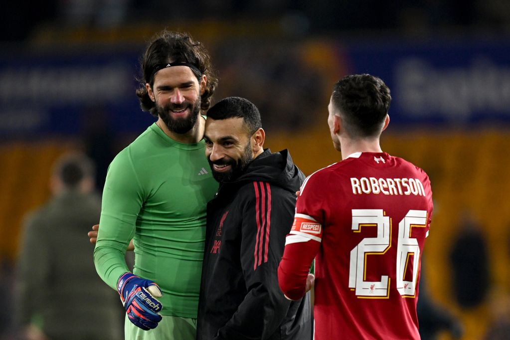 Alisson Becker, Mohamed Salah and Andy Robertson celebrate Liverpool's win over Wolves in the FA Cup.