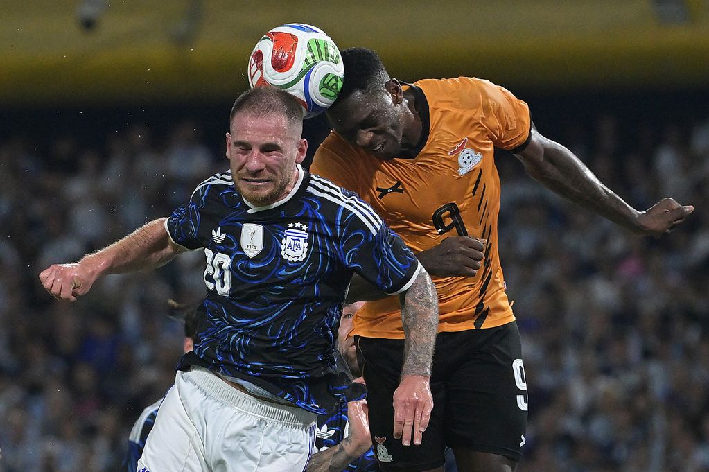 Alexis Mac Allister of Argentina jumps for the ball with Kingstone Mutandwa of Zambia during the international friendly match between Argentina and Zambia at Estadio Alberto J. Armando on March 31, 2026 in Buenos Aires, Argentina