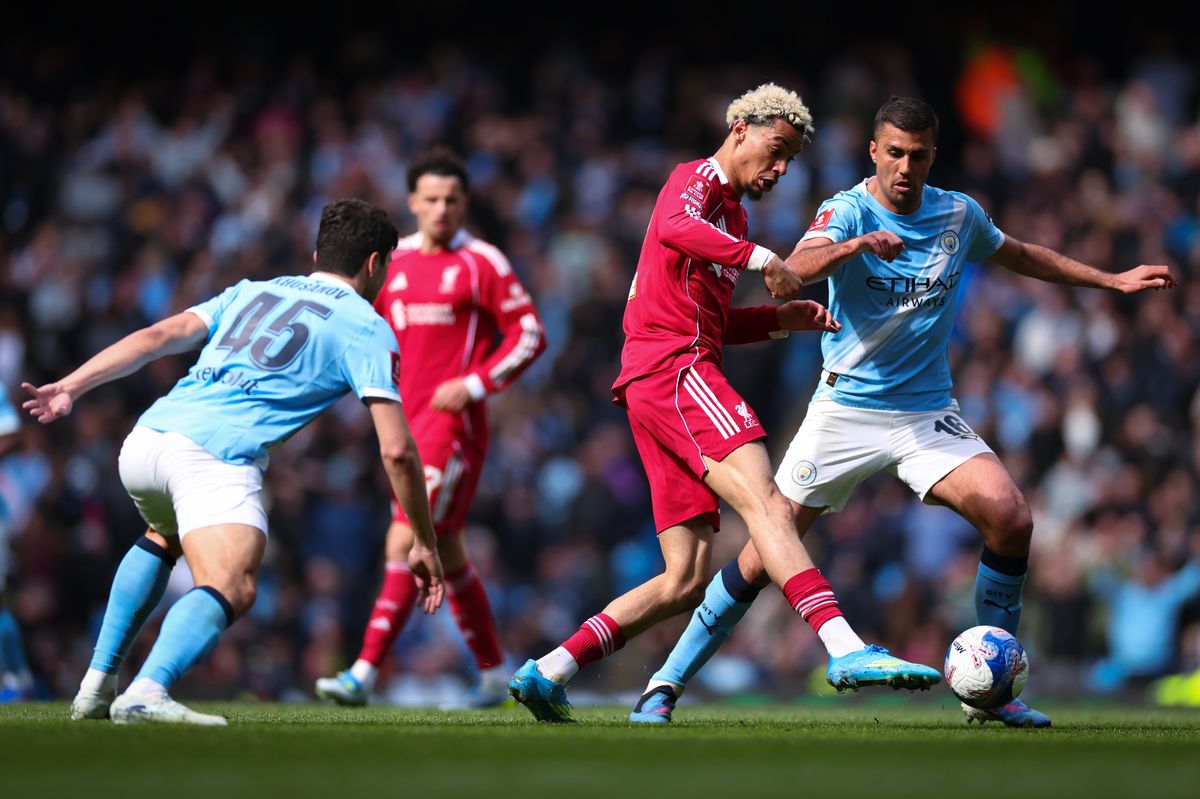 MANCHESTER, ENGLAND - APRIL 04: Hugo Ekitike of Liverpool under pressure from Abdukodir Khusanov and Rodrigo of Manchester City during the Emirates FA Cup Quarter Final match between Manchester City and Liverpool on April 04, 2026 in Manchester, England. (Photo by Marc Atkins/Getty Images)