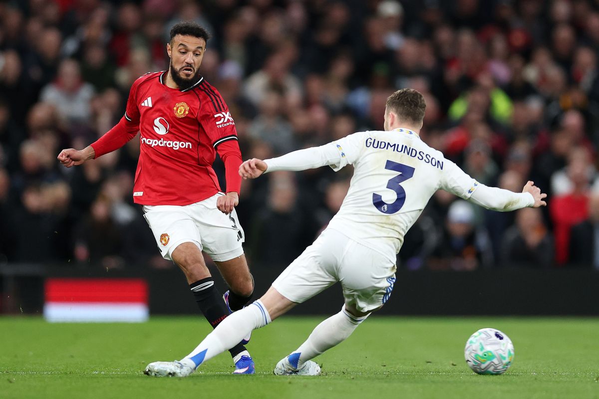 MANCHESTER, ENGLAND - APRIL 13: Noussair Mazraoui of Manchester United passes the ball while under pressure from Gabriel Gudmundsson of Leeds United during the Premier League match between Manchester United and Leeds United at Old Trafford on April 13, 2026 in Manchester, England. (Photo by Michael Regan/Getty Images)