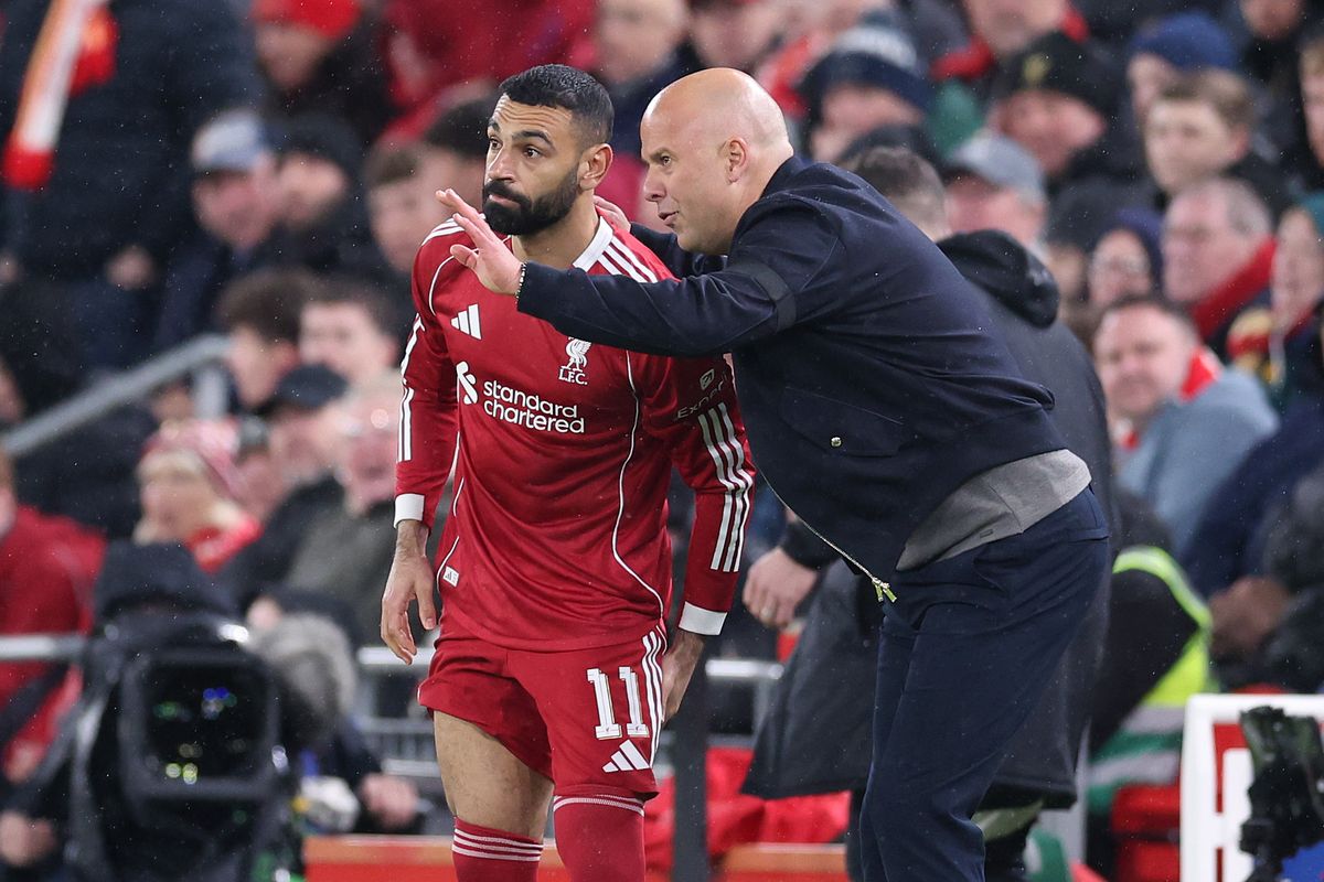 LIVERPOOL, ENGLAND - APRIL 14: Arne Slot, Manager of Liverpool talks with Mohamed Salah before bringing him on as substitute during the UEFA Champions League 2025/26 Quarter-Final Second Leg match between Liverpool FC and Paris Saint-Germain FC at Anfield on April 14, 2026 in Liverpool, England. (Photo by Alex Livesey - Danehouse/Getty Images)