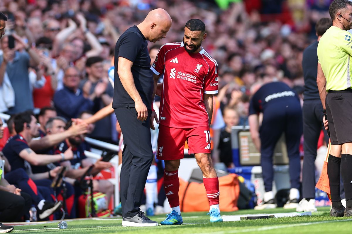 Arne Slot manager / head coach of Liverpool speaks with Mohamed Salah of Liverpool as he goes off injured  during the Premier League match between Liverpool and Crystal Palace