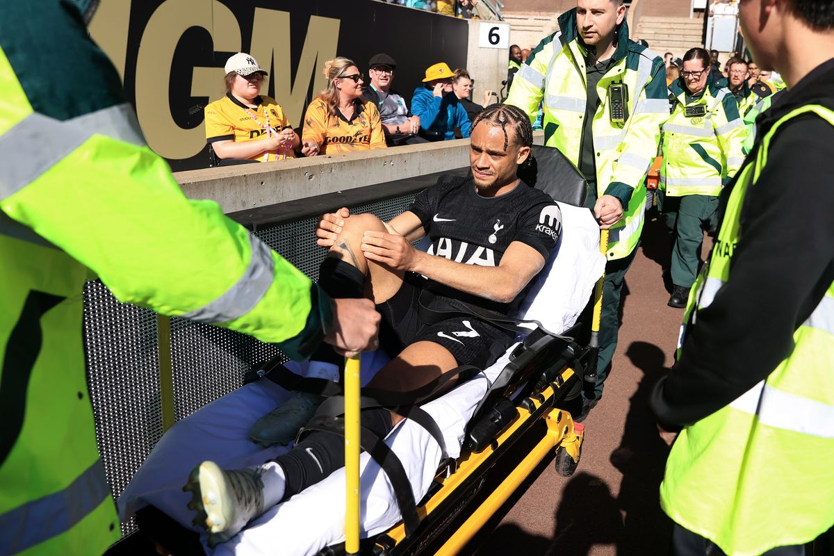 Xavi Simons of Tottenham Hotspur is taken away injured on a stretcher 