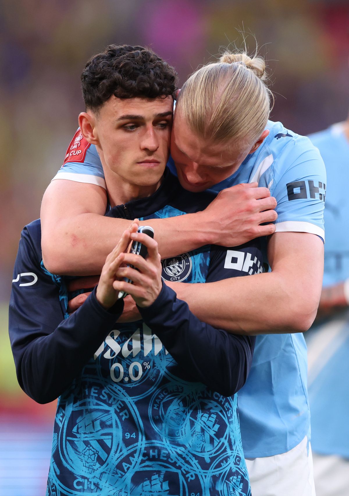 Erling Haaland embraces Phil Foden after a tough day at Wembley