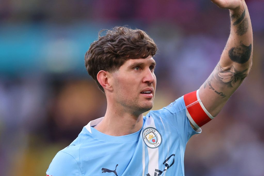 Man City defender John Stones waves to the crowd.
