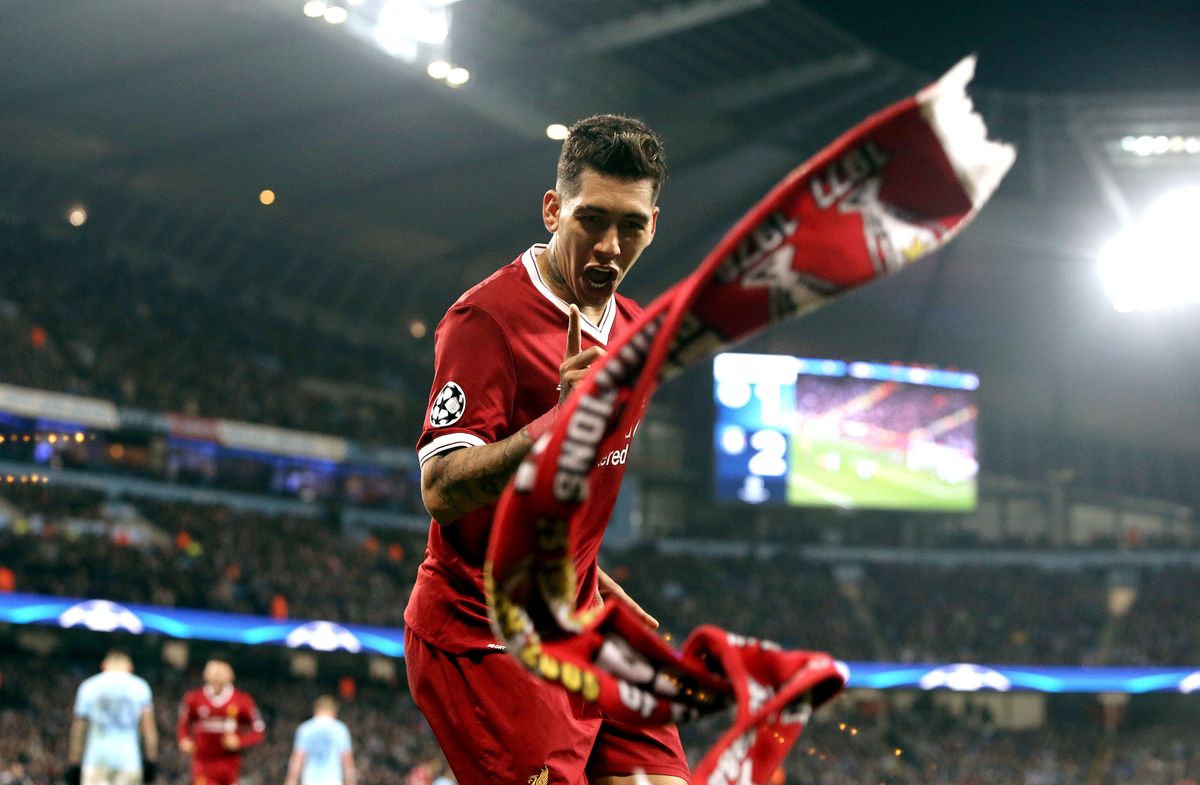 MANCHESTER, ENGLAND - APRIL 10:  A scarf is thrown by the Liverpool fans as Liverpool's Roberto Firmino celebrates scoring his side's second goal during the UEFA Champions League Quarter-Final Second Leg match between Manchester City and Liverpool at Etihad Stadium on April 10, 2018 in Manchester, England. (Photo by Rich Linley - CameraSport via Getty Images)
