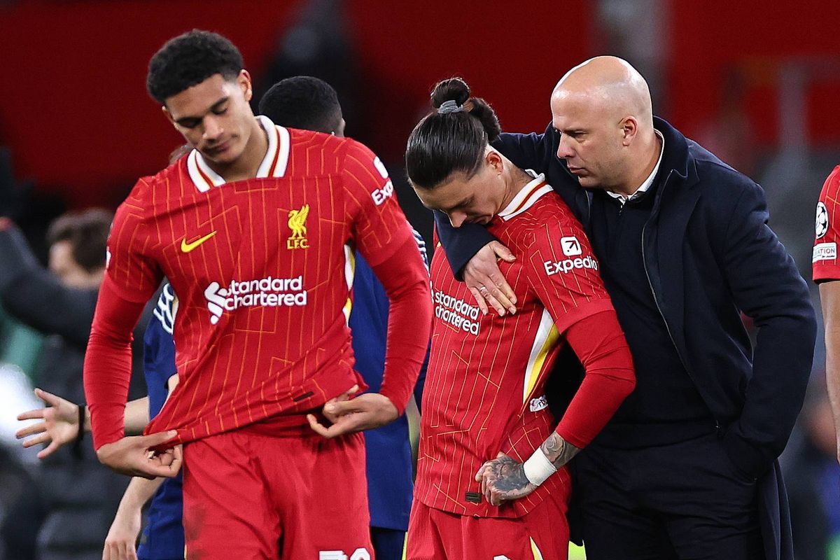 Arne Slot manager / head coach of Liverpool consoles Darwin Nunez of Liverpool after losing the penalty shoot out during the UEFA Champions League 2024/25 UEFA Champions League 2024/25 Round of 16 Second Leg match between Liverpool FC and Paris Saint-Germain at Anfield on March 11, 2025 in Liverpool, England.