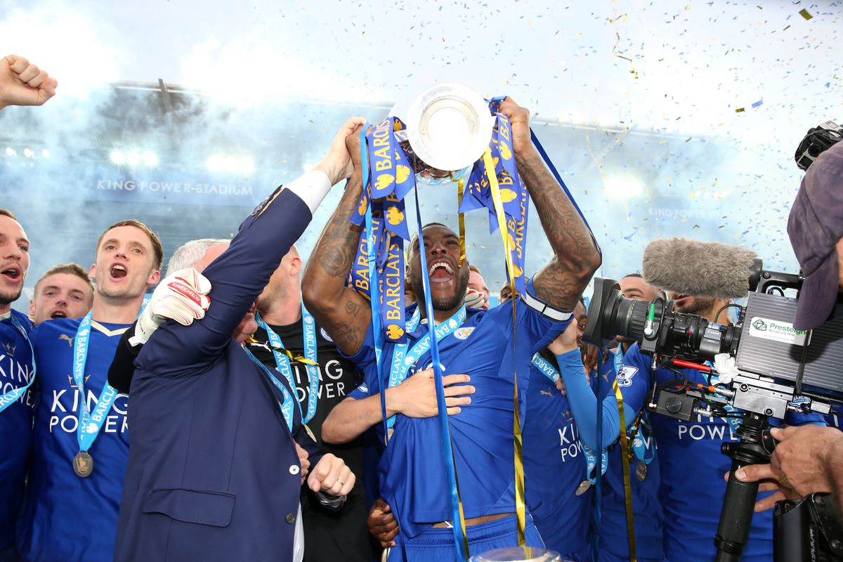 Leicester City legend Wes Morgan lifts the Premier League trophy in 2016