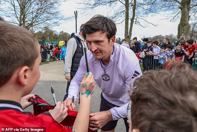 Harry Maguire stayed behind for an hour after United's training session to sign autographs for fans and take pictures with them
