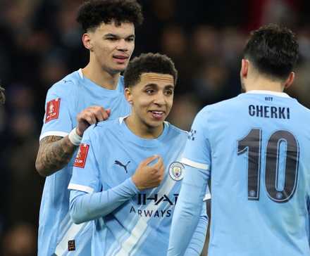 Manchester City's Nico O'Reilly celebrates scoring their eighth goal with Rico Lewis and Rayan Cherki