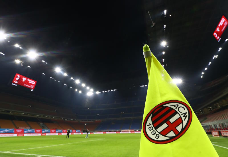 A corner flag with the AC Milan crest on it flutters after a game