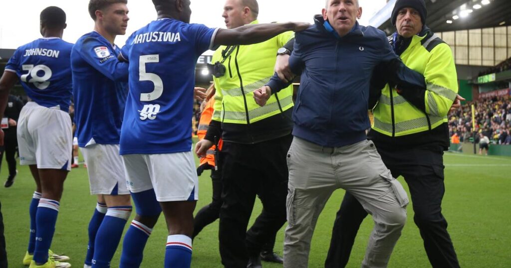 Photos show Ipswich fan invading pitch at Carrow Road