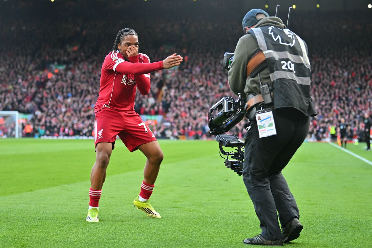 Liverpool's English striker #73 Rio Ngumoha celebrates for the TV camera after scoring the opening goal of the English Premier League football match between Liverpool and Fulham at Anfield in Liverpool, north west England on April 11, 2026. (Photo by ANDY BUCHANAN / AFP via Getty Images) / RESTRICTED TO EDITORIAL USE. No use with unauthorized audio, video, data, fixture lists, club/league logos or 'live' services. Online in-match use limited to 120 images. An additional 40 images may be used in extra time. No video emulation. Social media in-match use limited to 120 images. An additional 40 images may be used in extra time. No use in betting publications, games or single club/league/player publications. / 