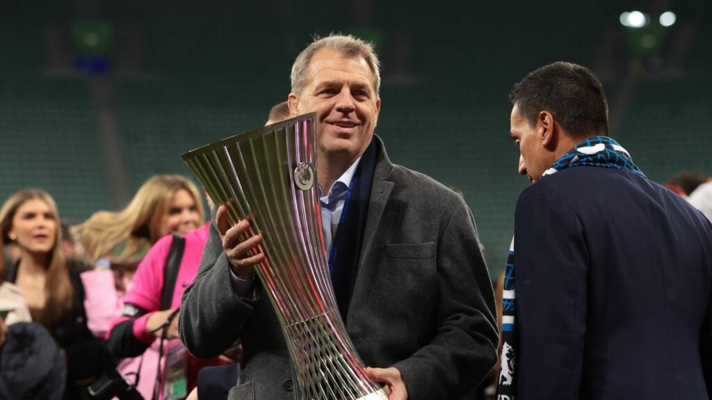 Chelsea owner Todd Boehly holding the Conference League trophy