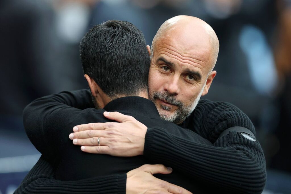 Pep Guardiola embraces Mikel Arteta before Manchester City play Arsenal at Etihad Stadium