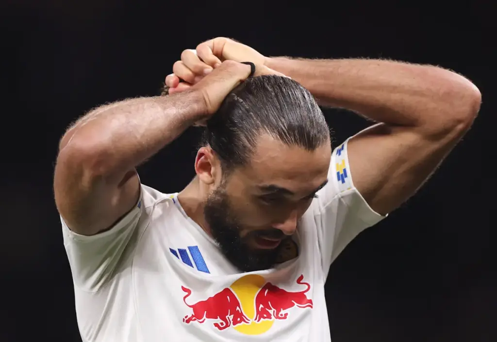 Leeds United striker Dominic Calvert-Lewin adjusts his hair during a match