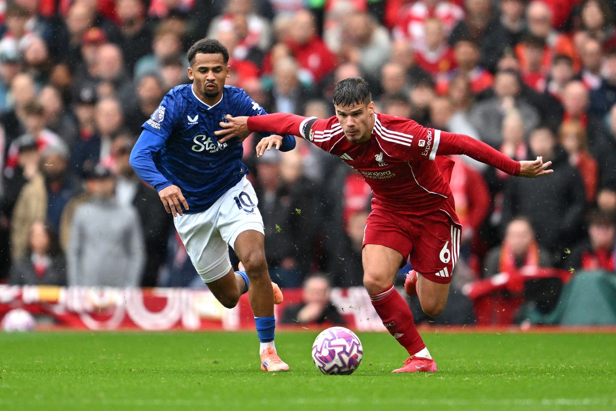 Milos Kerkez of Liverpool battles for possession with Iliman Ndiaye of Everton